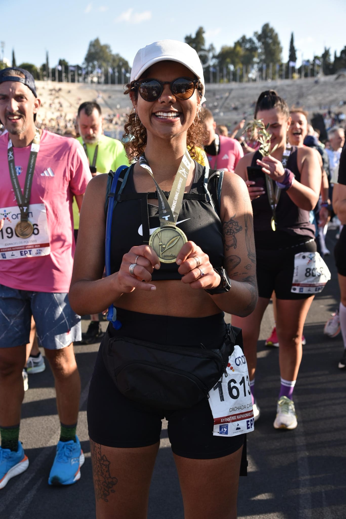 Finishing the Athens Marathon with a medal, Panathenaic Stadium in the background
